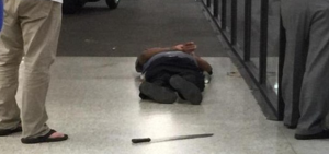 Machete wielding attacker lies handcuffed after being shot at New Orleans airport. Photo: Twitter