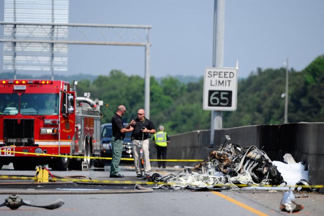 Officials investigate a deadly airplane crash after the single-engine aircraft slammed into a median wall on the heavily traveled I-285 interstate highway and stopped traffic in all directions in Doraville, Georgia, just north of metro Atlanta, May 8, 2015. According to authorities, four persons aboard the Piper PA-32 aircraft that departed nearby Dekalb-Peachtree Airport died in an ensuing fire after the plane crashed but passing motorists escaped injury. Photo by David Tulis/UPI | License Photo