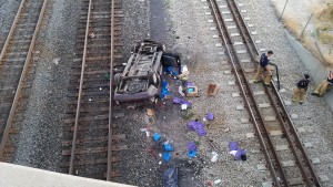 Two women in critical condition after the van they were in veered off the roadway on 3900 South and landed on the railroad tracks below - Photo: Gephardt Daily 