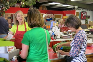 Pettingill's store manager, Jean P. Davis (left), chats with customers as they pay for their purchases. Photo: Gephardt Daily/Nancy Van Valkenburg