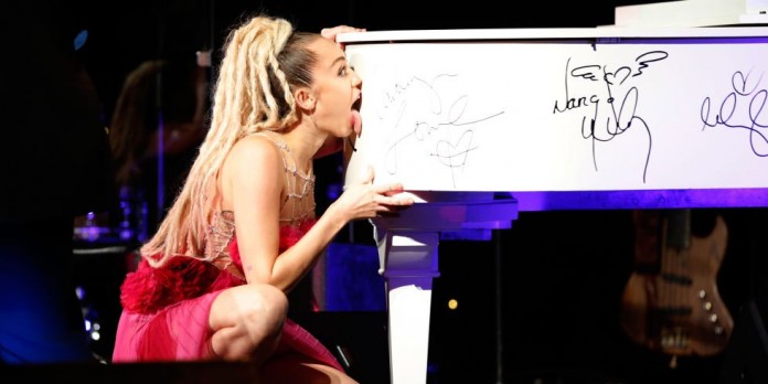 Miley Cyrus Licks Grand Piano for Charity