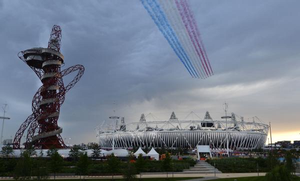 The Royal Air Force aerobatic team, known as the Red Arrows, fly over the Olympic Stadium for the opening ceremony of the 2012 Summer Olympics in London on July 27, 2012. UPI/Brian Kersey