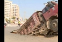 Road Collapses Beneath Overloaded Truck