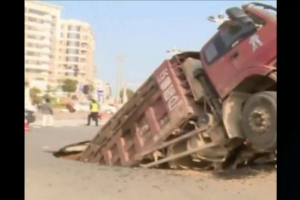 Road Collapses Beneath Overloaded Truck