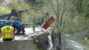 Crews pulled a car out of the river after a man veered off the road and crashed through the barriers. Photo Courtesy: Weber County Sheriff