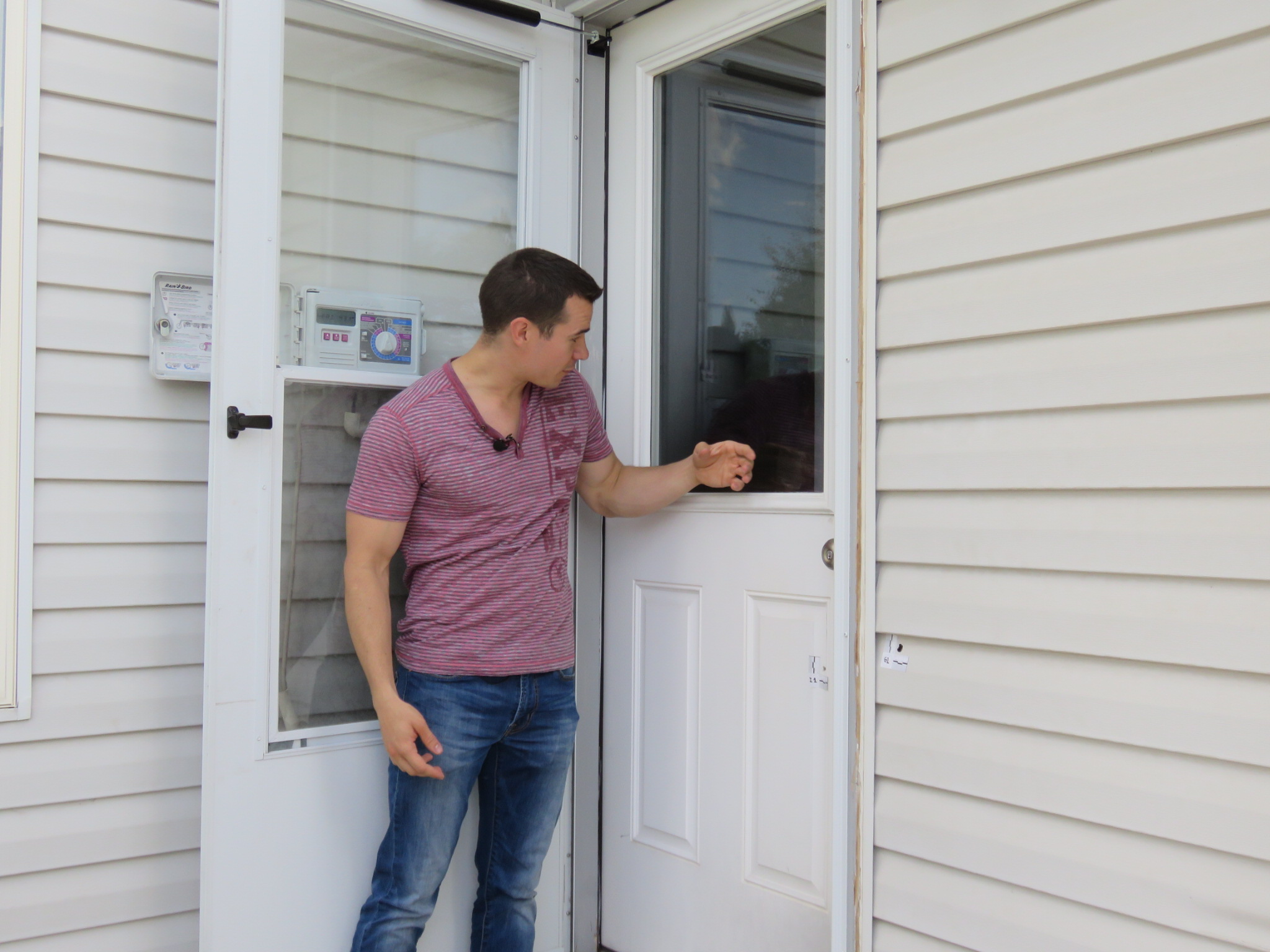 The owner of the Taylorsville home shot at Friday morning shows reporters some of the damage. Photo: Gephardt Daily