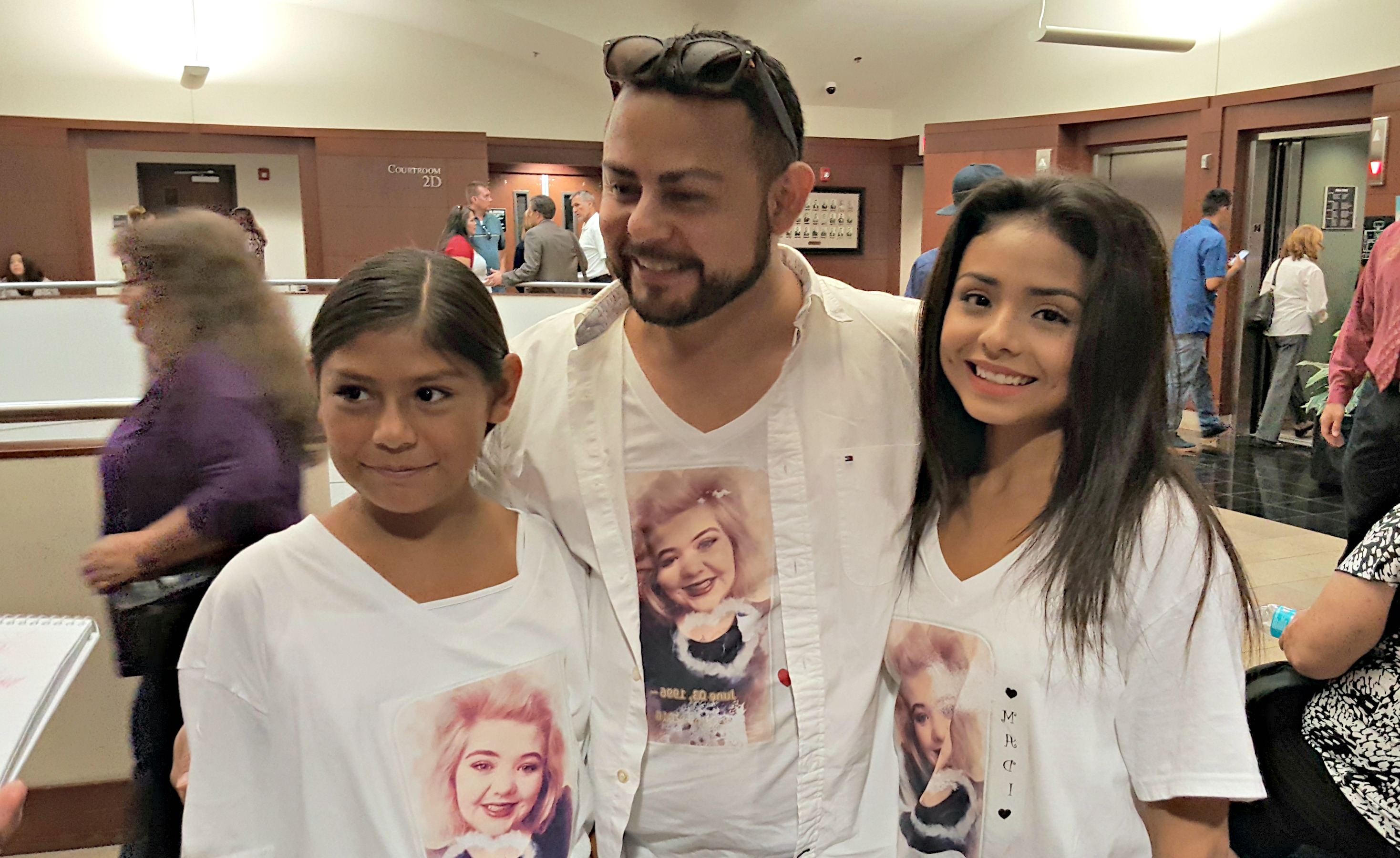 Alicia Castillo (left), 11, and Audrie Castillo, 18, show off the T-shirts their uncle Lee Castillo (center) made for them and other of Maddison Haan's family members to wear to court. Photo: Gephardt Daily