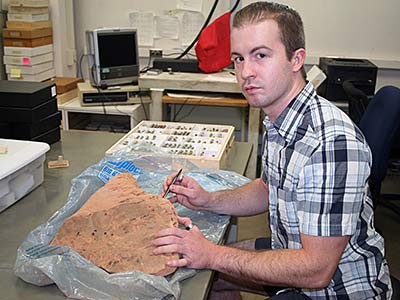 Biology doctoral student Michael Orr examines sandstone nests retired USDA-ARS entomologist Frank Parker discovered in Utah’s San Rafael Desert nearly 40 years ago. Photo: Utah State University
