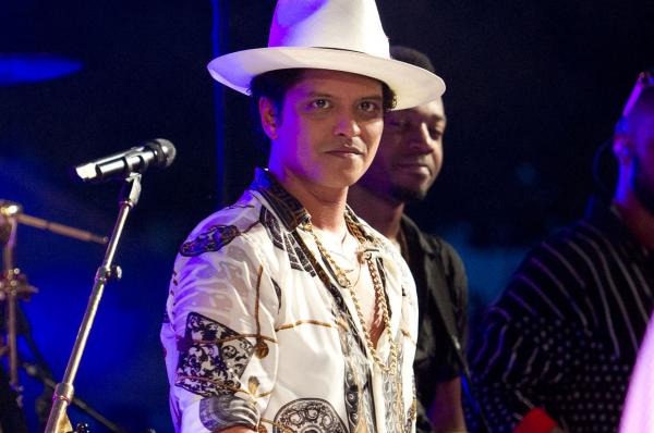 Performer Bruno Mars looks on as United States President Barack Obama makes remarks to members of the military and White House staff on the South Lawn of the White House in Washington, D.C. on July 4, 2015. File Pool photo by Ron Sachs/UPI 