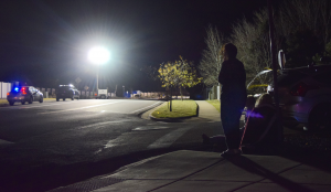 Bystanders watch police investigators on the scene of a fatal accident which killed two 16-year-olds and injured tree others Friday night in Draper. Photo: Gephardt Daily/Patrick Benedict