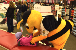 Bumble, mascot for the Salt Lake Bees joins Unified District police and firefighters with helping kids shop for clothes and footwear by way of the Unified for Families project, Dec. 17. 2016. Gephardt Daily