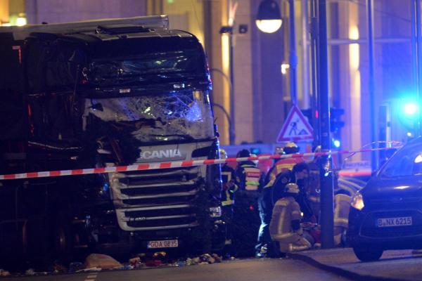Rescue workers inspect the scene where a truck crashed into a Christmas market, close to the Kaiser Wilhelm memorial church in Berlin on Monday. According to police, several people were killed and many were injured. Photo by Paul Zinken/European Pressphoto Agency