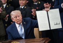 President Donald Trump holds a signed executive order instructing the Federal Communications Commission and Secretary of Commerce to ensure the Army-Navy football game has an exclusive broadcast window during the Commander in Chief's Trophy to the Navy Midshipmen football team in the East Room of the White House on Friday. Photo by Bonnie Cash/UPI