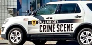 White Salt Lake City crime-scene police SUV with bold 'CRIME SCENE' lettering on the side and a city badge emblem.