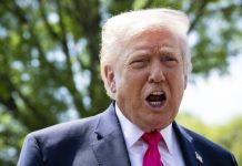 U.S. Navy fires on Iranian ship; Trump officials head to peace talks Public figure with white hair speaking outdoors, wearing a navy suit and bright pink tie, mouth open as he talks.