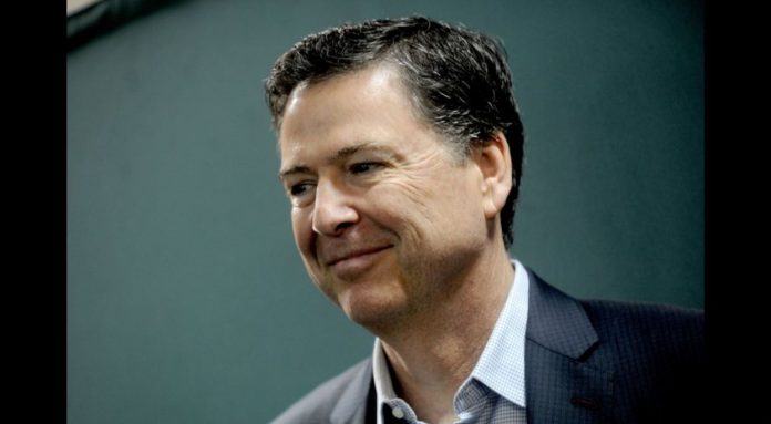 Smiling man in a dark blazer and light shirt, looking slightly to the right (profile portrait).”,