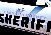 Close-up of a Franklin County Sheriff patrol car with bold black SHERIFF lettering on the side of a white police vehicle as part of the squad car branding.