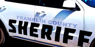 Close-up of a Franklin County Sheriff patrol car with bold black SHERIFF lettering on the side of a white police vehicle as part of the squad car branding.