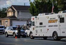 2nd man arrested after May 30 West Point homicide Davis County Sheriff mobile command center vehicle parked on a city street beside a cone and several cars, with a two-story house in the background and people nearby.