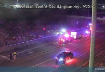Night-time view of Old Bingham Hwy with emergency vehicles flashing lights; two people stand near the road as a car is pulled over, timestamp 03:20 AM 05/23/2026.