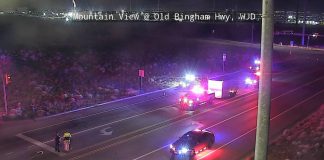 Night-time view of Old Bingham Hwy with emergency vehicles flashing lights; two people stand near the road as a car is pulled over, timestamp 03:20 AM 05/23/2026.