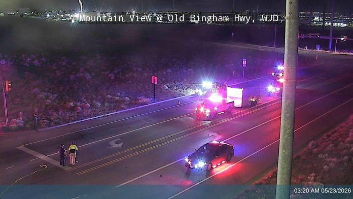 Night-time view of Old Bingham Hwy with emergency vehicles flashing lights; two people stand near the road as a car is pulled over, timestamp 03:20 AM 05/23/2026.