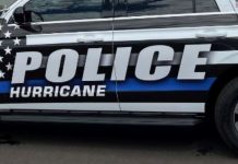 Side view of a police SUV with bold 'POLICE HURRICANE' lettering and an American flag decal on the window.
