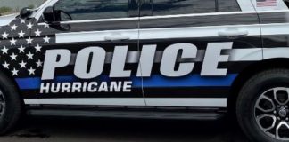 Side view of a police SUV with bold 'POLICE HURRICANE' lettering and an American flag decal on the window.