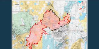 Geographic map with a red irregular boundary outlining a large region over varied terrain; inset locator map in the top-right corner.