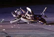 Two boys critically injured in Herriman electrical motorcycle collision with vehicle Bicycle crashed on a dark road at night; bike on its side with a bent wheel and scattered debris around it.
