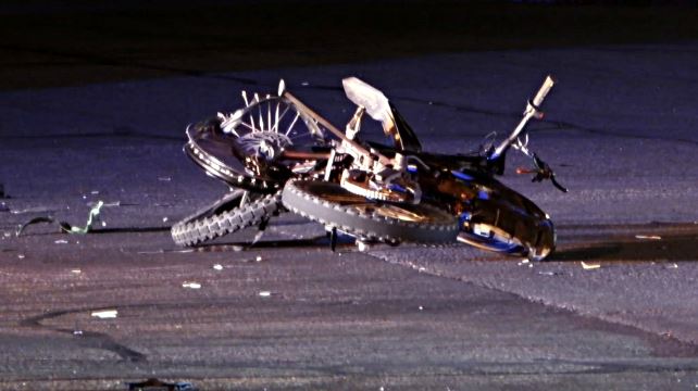 Herriman 1 | Gephardt Daily Bicycle crashed on a dark road at night; bike on its side with a bent wheel and scattered debris around it.