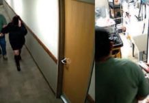 Two former clerks at Logan Municipal Justice Court indicted for allegedly helping undocumented immigrants evade ICE arrest Two people walk down a hallway toward an open door on the left; a person in a green shirt works at a cluttered lab or kitchen counter on the right.