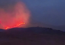 South Mountain Fire burns more than 200 acres west of Stockton in Tooele County Lava flow down a hillside at dusk, with bright red molten rock glowing against a dark sky