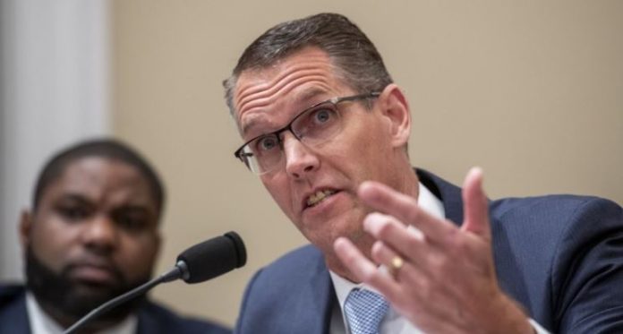 Trump-pick-loses-in-Iowa-Karen-Bass-advances-to-LA-mayoral-runoff Man in glasses and a blue suit speaks into a microphone, gesturing with his hand at a panel discussion.