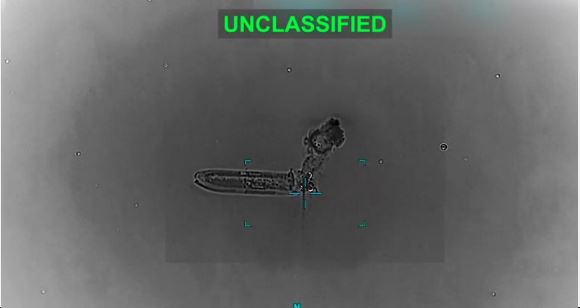 US-hits-oil-tanker-in-the-Gulf-of-Oman-3-Indian-nationals-missing Infrared surveillance image showing a small elongated vessel with a plume, labeled UNCLASSIFIED in bright green at the top.