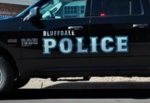 Black Bluffdale Police pickup with large blue 'POLICE' lettering on the side, parked on a street.
