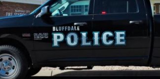 Black Bluffdale Police pickup with large blue 'POLICE' lettering on the side, parked on a street.