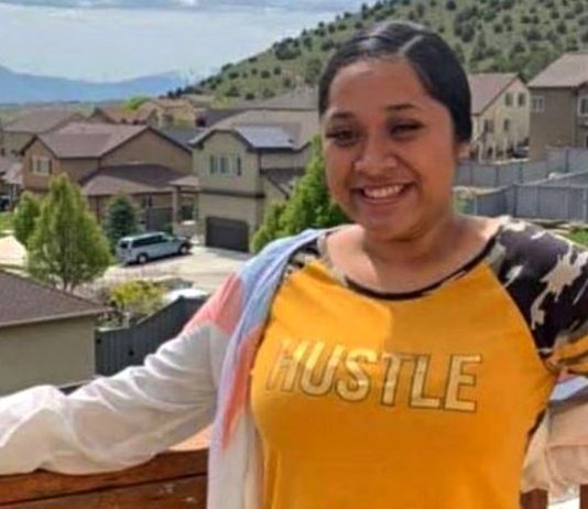 Tribute, fundraising account established for woman killed in I-215 Taylorsville collision Woman smiling on a wooden balcony overlooking a suburban neighborhood with houses and hills in the distance.