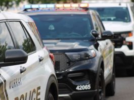 Unified PD: Bicyclist critically injured after Midvale collision with stopped car Row of police SUVs with flashing emergency lights parked on a street, showing police markings.