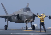 Defense Department identifies 2 U.S. soldiers killed in last week’s Iranian attack in Jordan F-35 fighter jet on a carrier deck with a crew member in a yellow vest signaling with raised arms.