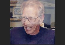 Search underway in Grand Canyon for missing 83-year-old hiker from Kanab Older man with glasses smiling and laughing, in a dark shirt.
