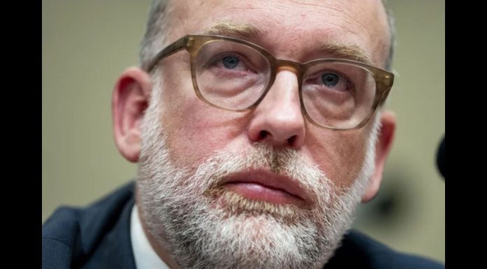 Trump-administration-admits-it-canceled-grants-from-Harris-voters Close-up portrait of a middle-aged man with a gray beard and brown glasses, looking upward thoughtfully.