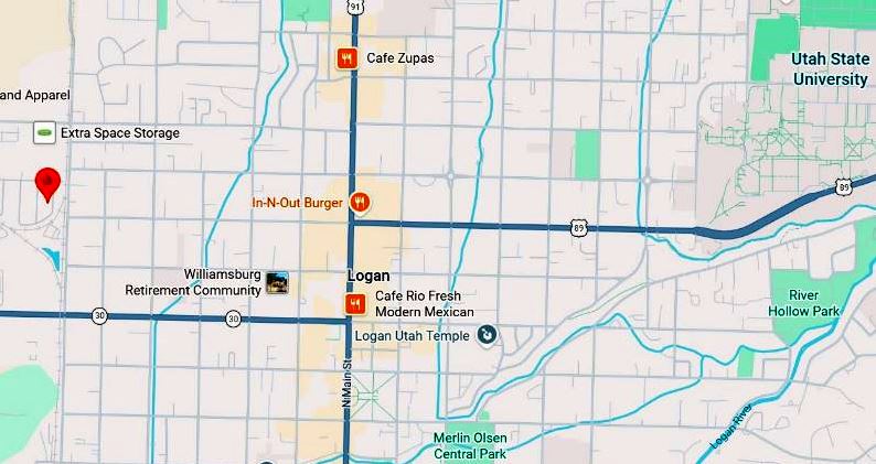 Map of Logan Utah area with major roads and labeled landmarks Cafe Rio In N Out Burger Utah State University and a red pin west of downtown near Extra Space Storage NationStorage symbol